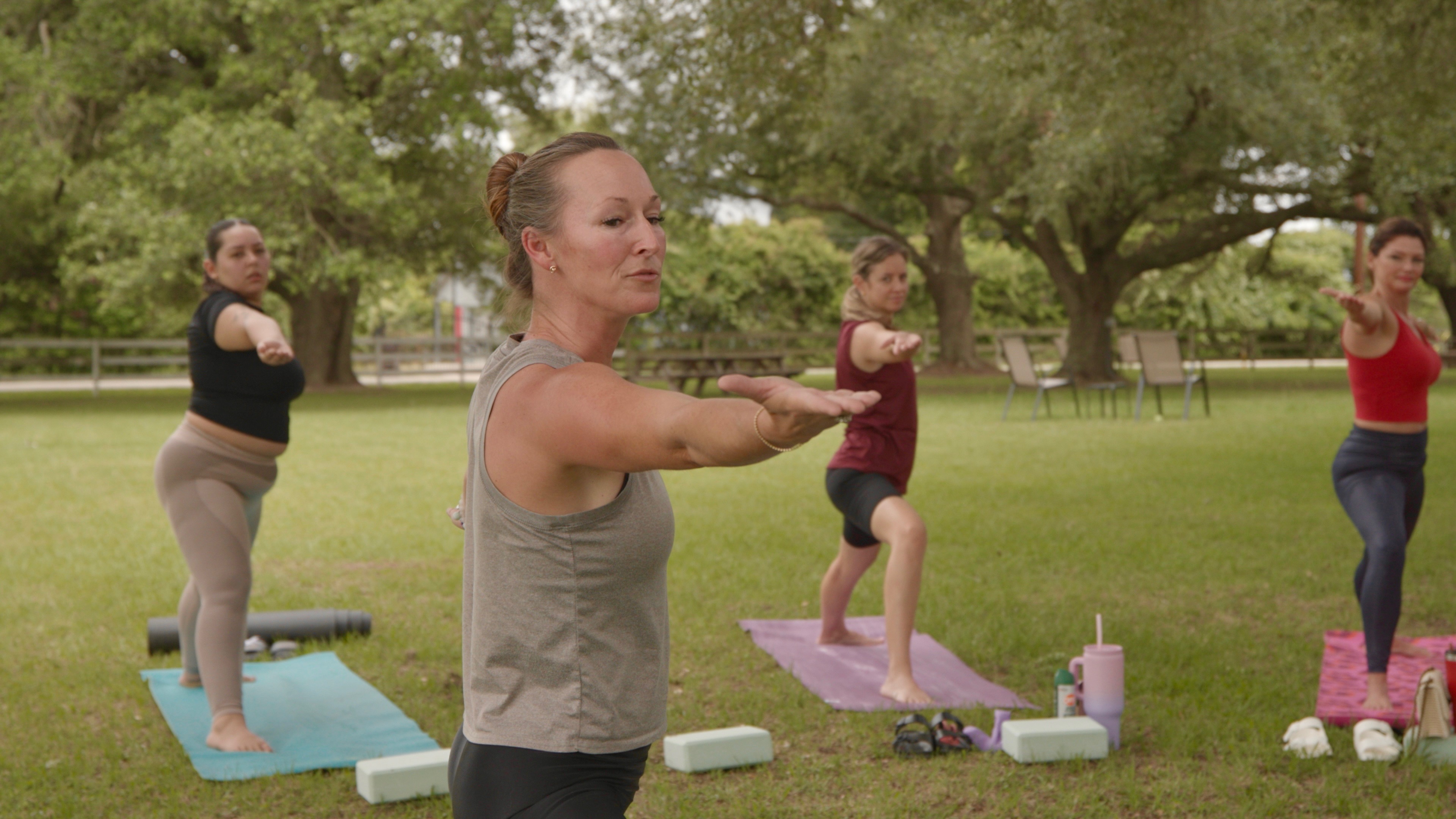 Women's yoga class by the pool